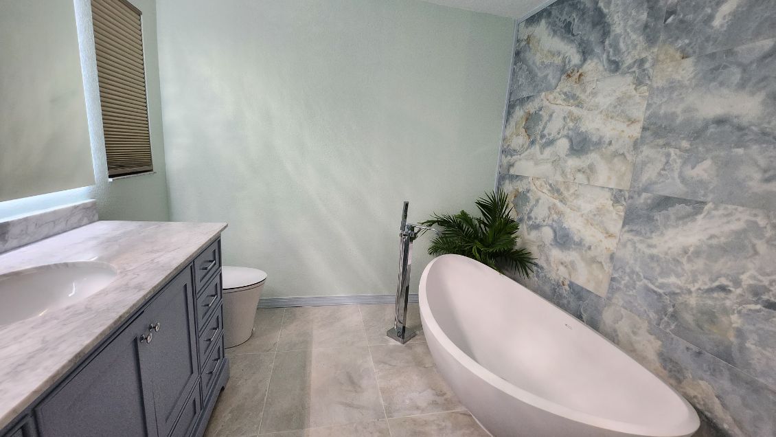 Marble countertop vanity addition, custom bathtub setup, wall repaint and retiling, decor