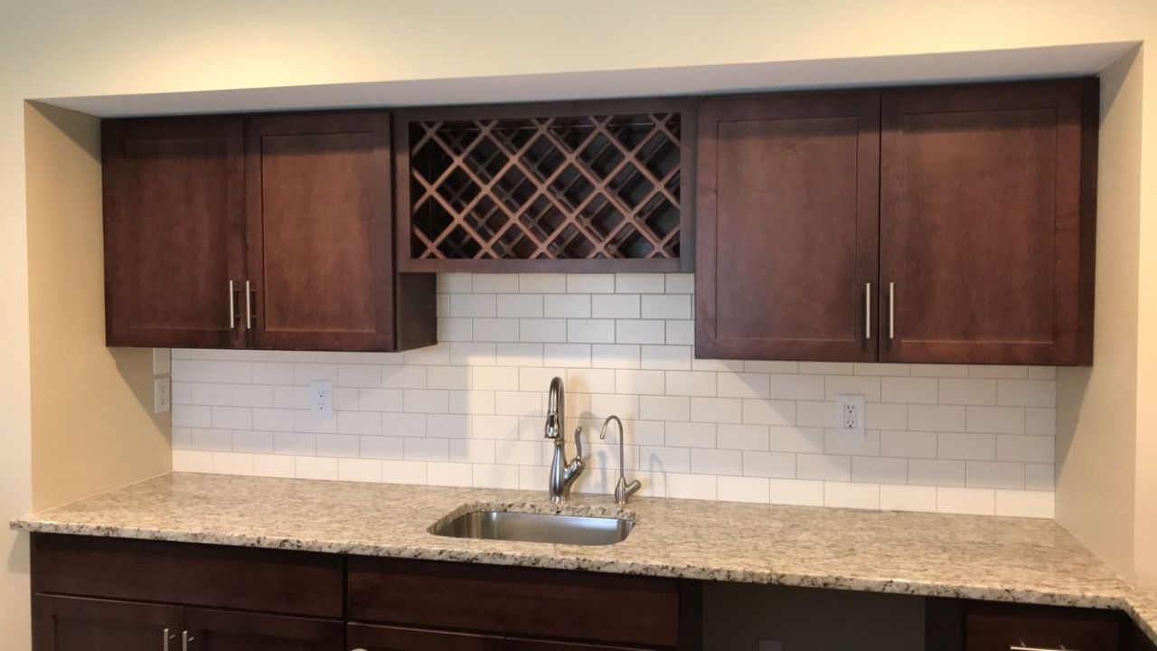 Luxury kitchen with custom tile backsplash and marble countertop