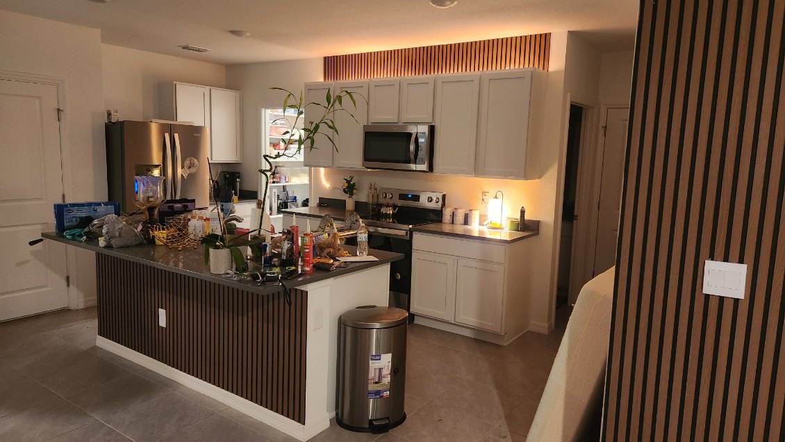 Luxury kitchen with custom tile backsplash and granite island