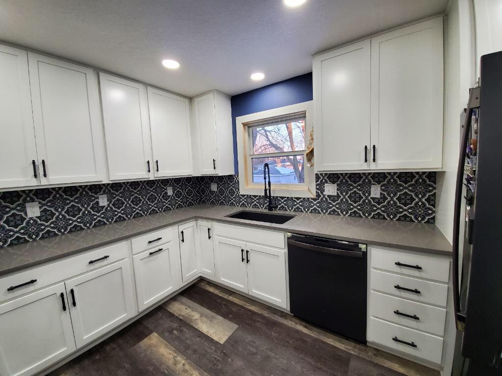 Luxury kitchen with custom tile backsplash and granite island