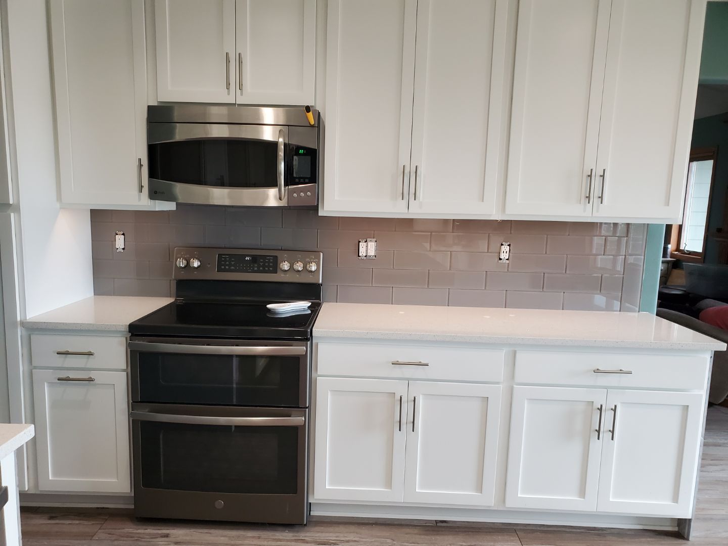 Luxury kitchen with custom tile backsplash and marble countertop