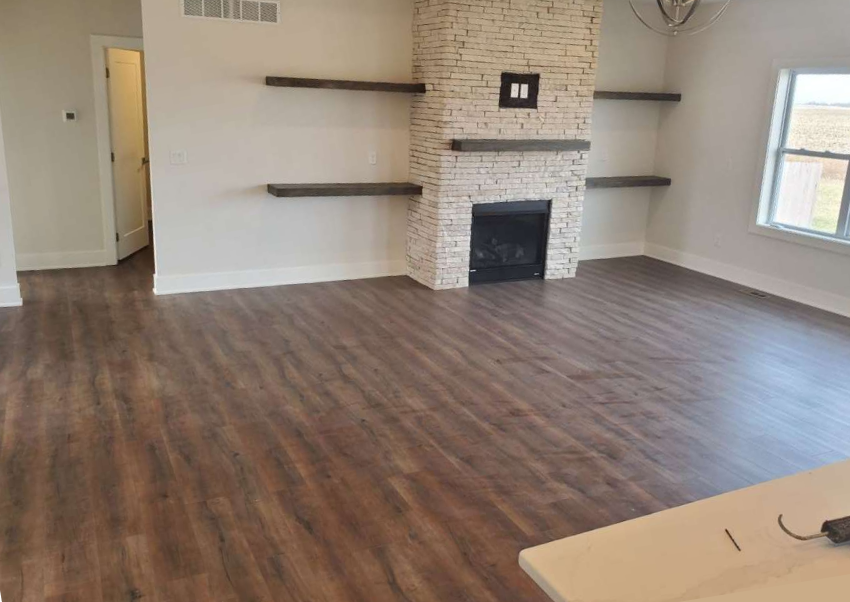 Family room addition with vaulted ceilings, fireplace and light fixture