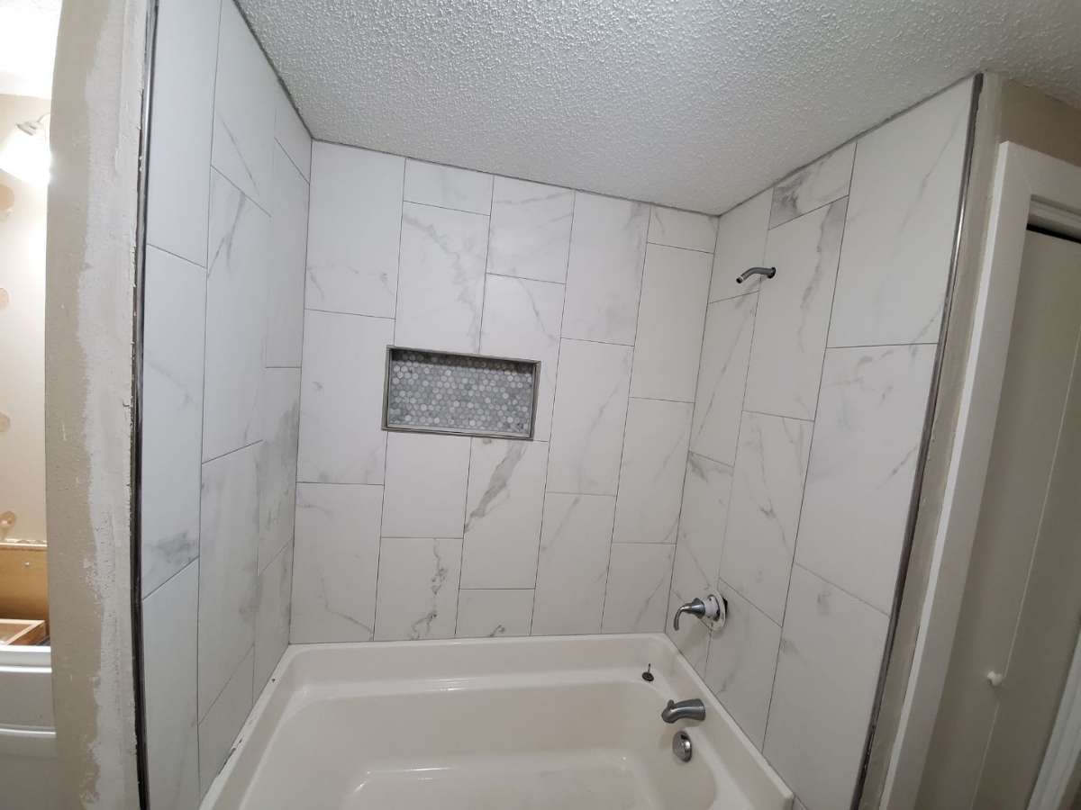 Spa-like bathroom renovation with marble shower and custom vanity